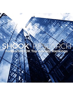 Skyscrapers with Shook Research and Forbes/SHOOK Top Advisor Rankings text overlay in a blue tone.