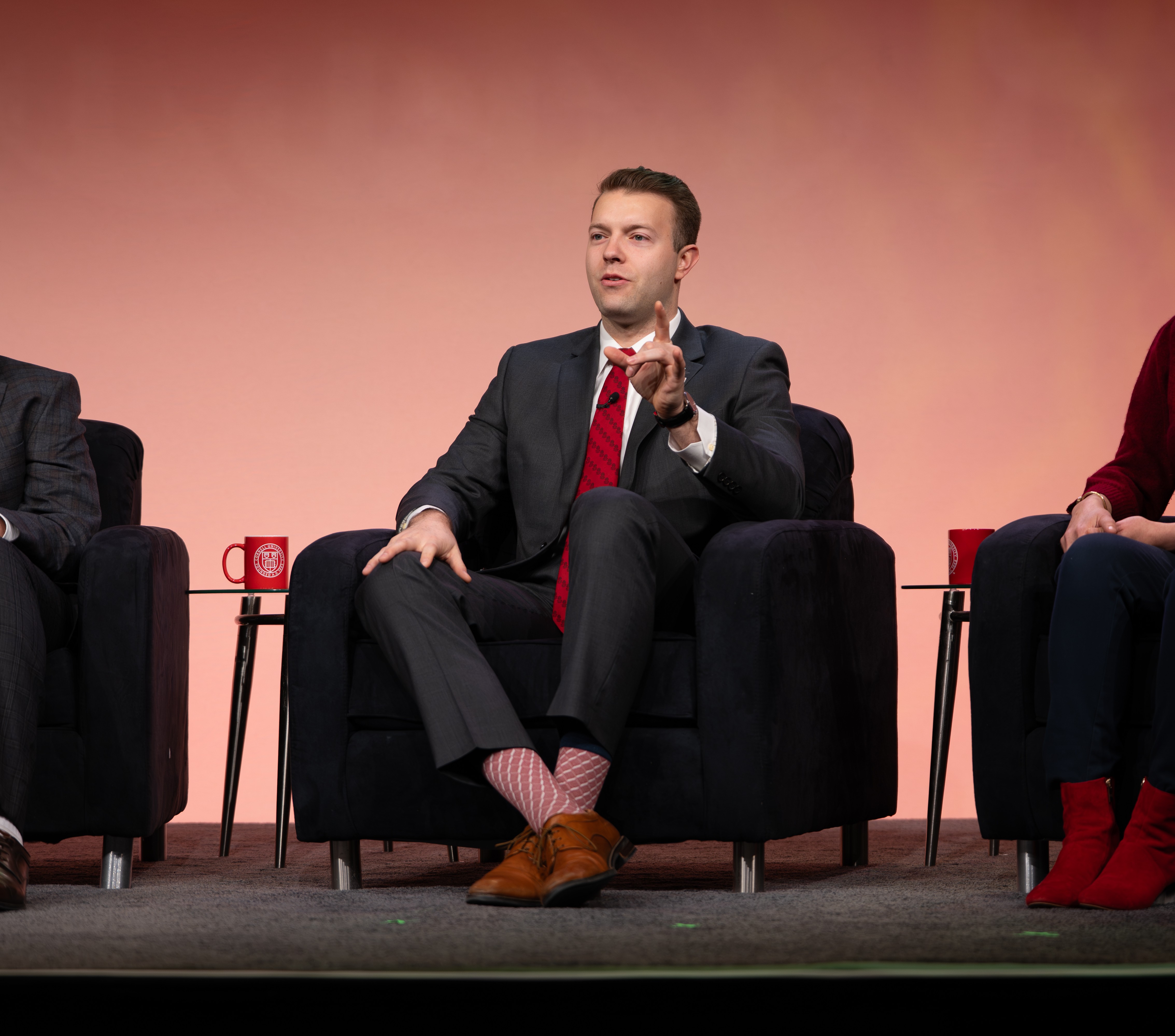 Person speaking on stage during panel discussion.