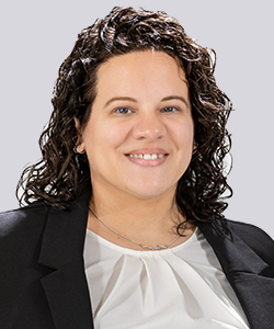 Woman smiling in business attire.