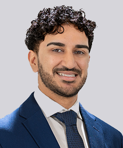 Man in blue suit smiling.