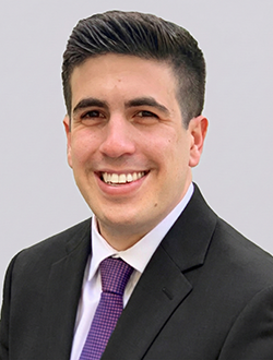 Smiling person in a suit and tie