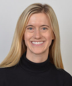 Smiling blonde woman in black turtleneck portrait